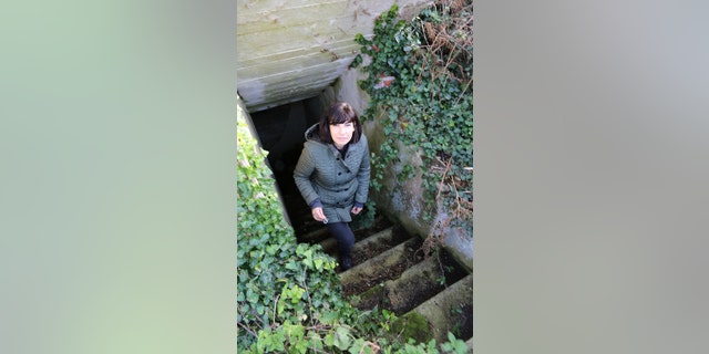 Prof Caroline Sturdy Colls ascending steps from old underground tunnel system on Alderney. — SNI/SI Networks L.L.C.