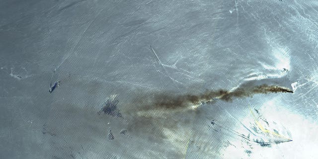 This June 13, 2019 false-color image from the European Commission's Sentinel-2 satellite that was processed by Sinergise's Sentinel Hub website shows the Norwegian-owned MT Front Altair ablaze with smoke rising from it in the Gulf of Oman after what the U.S. described as a limpet mine attack by Iran. Iran has denied being involved in the incident. The white light in the image is the sun being reflected off the waters of the Gulf of Oman.