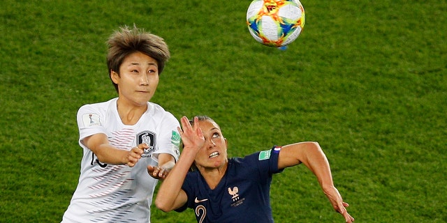 France's Eve Perisset, left, challenges for the ball with South Korea's Yeo Min-ji during the Women's World Cup Group A soccer match at the Parc des Princes in Paris, Friday, June 7, 2019. (Associated Press)