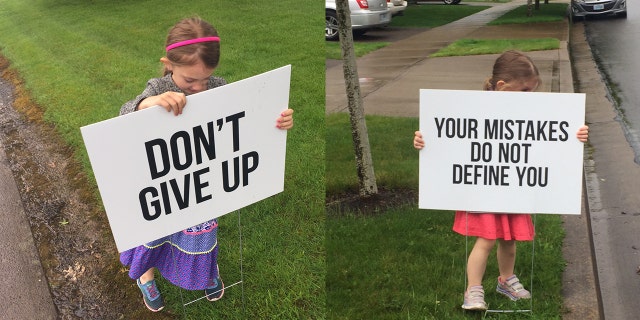 The founder's young daughters, pictured, have helped set up the famous signs.