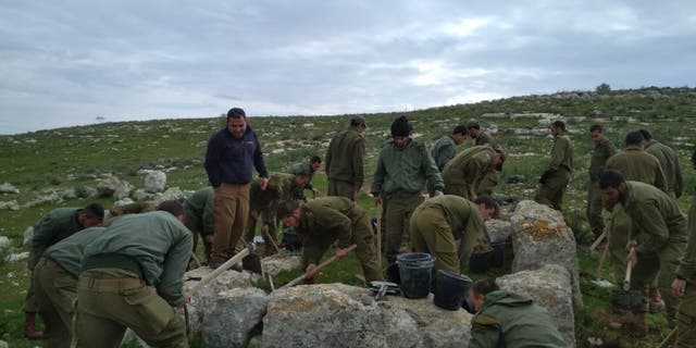 Israeli soldiers taking part in the excavation of the ancient watchtower.