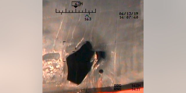 This image released by the U.S. Department of Defense on Monday, June 17, 2019, and taken from a U.S. Navy helicopter, shows what the Navy says is blast damage to the motor vessel M/T Kokuka Courageous, consistent with a limpet mine attack. (U.S. Department of Defense via AP)