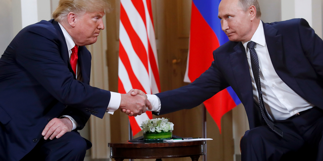 In this July 16, 2018, file photo, U.S. President Donald Trump, left, and Russian President Vladimir Putin shake hands at the beginning of a meeting at the Presidential Palace in Helsinki, Finland. (AP Photo/Pablo Martinez Monsivais)
