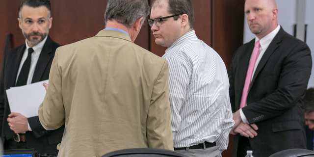 Defense attorney Boyd Young talks with Tim Jones, center, during the sentencing phase of his trial in Lexington, S.C. Timothy Jones, Jr. was found guilty of killing his 5 young children in 2014. (Tracy Glantz/The State via AP, Pool)