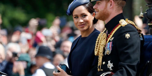 Britain's Meghan, the Duchess of Sussex and Prince Harry ride in a carriage to attend the annual Trooping the Colour Ceremony in London