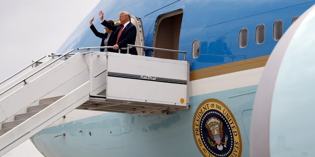 President Donald Trump walks from Air Force One with Iowa Gov. Kim Reynolds at Des Moines International Airport in Des Moines, Iowa, Tuesday, June 11, 2019, to attend a fundraiser in West Des Moines. (Associated Press)