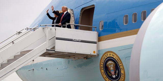 President Donald Trump walks from Air Force One with Iowa Gov. Kim Reynolds at Des Moines International Airport in Des Moines, Iowa, Tuesday, June 11, 2019, to attend a fundraiser in West Des Moines. (Associated Press)
