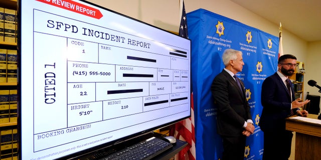 With a blind police incident report displayed, San Francisco District Attorney George Gascon, left, and Alex Chohlas-Wood, Deputy Director, Stanford Computational Policy Lab, talk about the implementation of an artificial intelligence tool to remove potential for bias in charging decisions, on June 12, 2019, in San Francisco. (AP Photo/Eric Risberg)