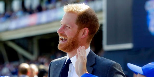 British Prince Harry talks to children at the opening ceremony of the World Cup cricket match between England and South Africa at The Oval in London. 