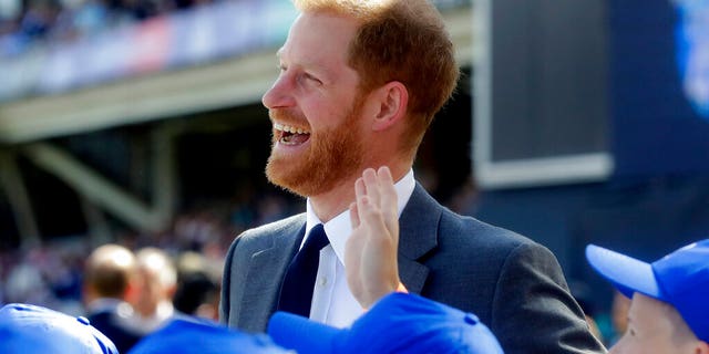 Britain's Prince Harry speaks to children during the opening ceremony of the World Cup cricket match between England and South Africa at The Oval in London.