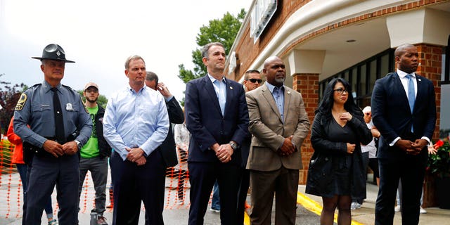 Virginia Gov. Ralph Northam, center, attends a vigil in response to a shooting at a municipal building in Virginia Beach, Va., Saturday morning. A longtime city employee opened fire at the building Friday, with lethal consequences, before police shot and killed him, authorities said. (AP Photo/Patrick Semansky)