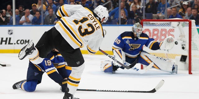 Boston Bruins center Charlie Coyle (13) scores a goal against St. Louis Blues goaltender Jordan Binnington (50) during the first period of Game 3 of the NHL hockey Stanley Cup Final on Saturday in St. Louis. (Associated Press)