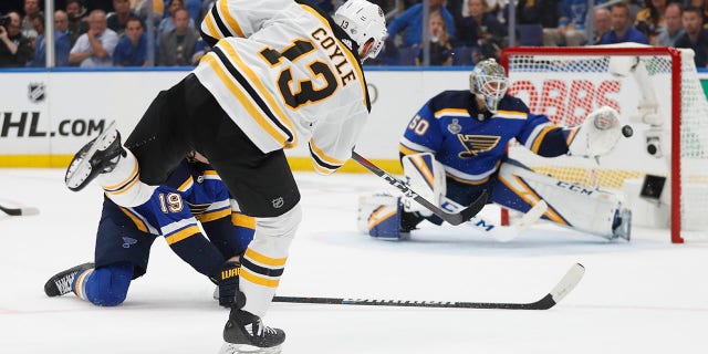 Boston Bruins center Charlie Coyle (13) scores a goal against St. Louis Blues goaltender Jordan Binnington (50) during the first period of Game 3 of the NHL hockey Stanley Cup Final on Saturday in St. Louis. (Associated Press)