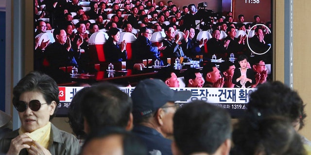 People watch a TV screen showing an image of North Korean leader Kim Jong Un, third from left, and senior North Korean official Kim Yong Chol, right, in a musical performance by the wives of Korean People's Army officers in North Korea during a news program at the Seoul Railway Station in Seoul, South Korea.
