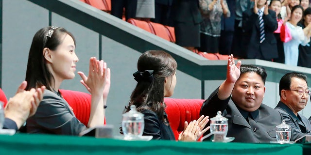 In this June 3, 2019, North Korean leader Kim Jong Un, second right, waves with his wife Ri Sol Ju, center, during the grand gymnastics and artistic performance at the May Day Stadium in Pyongyang. The woman next to Ri Sol Ju appears to be Kim's sister, Kim Yo Jong, who state media said attended the performance. (Korean Central News Agency/Korea News Service via AP)