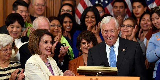 House Speaker Nancy Pelosi of Calif., front left, shakes hands with House Majority Leader Steny Hoyer, D-Md., during an event to support the American Dream and Promise Act. (AP Photo/Susan Walsh)