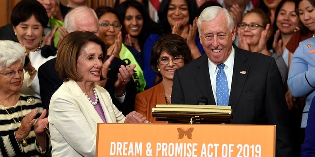 House Speaker Nancy Pelosi of Calif., front left, shakes hands with House Majority Leader Steny Hoyer, D-Md., during an event to support the American Dream and Promise Act. (AP Photo/Susan Walsh)