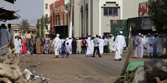 Worshippers gather at a mosque behind a roadblock set by protesters on a main street in the Sudanese capital Khartoum to stop military vehicles from driving through the area on Wednesday, June 5, 2019. (AP Photo)