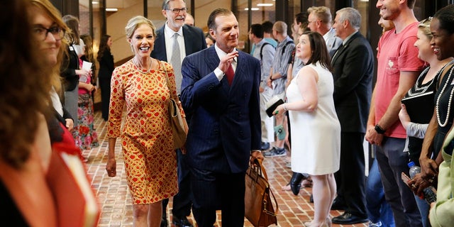 In this Sept. 20, 2018, photo, Hugh F. Culverhouse Jr. and his wife, Eliza, enter the University of Alabama law school in Tuscaloosa, Ala. The university appears poised to reject a $26.5 million pledge by Culverhouse, who recently called on students to boycott the university over the state’s new abortion ban. (Gary Cosby Jr./The Tuscaloosa News via AP)