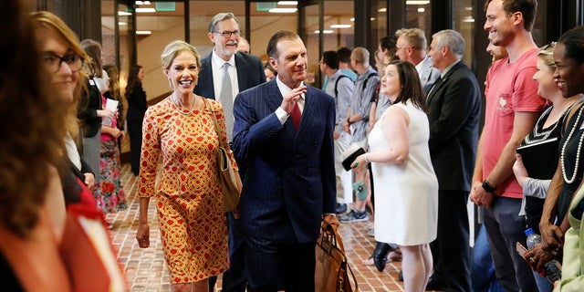 In this Sept. 20, 2018, photo, Hugh F. Culverhouse Jr. and his wife, Eliza, enter the University of Alabama law school in Tuscaloosa, Ala. The university appears poised to reject a $26.5 million pledge by Culverhouse, who recently called on students to boycott the university over the state’s new abortion ban. (Gary Cosby Jr./The Tuscaloosa News via AP)