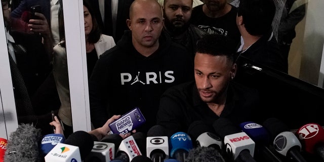Brazilian soccer player Neymar speaks to journalists as he leaves a police station in Rio de Janeiro, Brazil, Thursday, June 6, 2019. Neymar went to the Rio de Janeiro police headquarters Thursday evening in an investigation linked to a woman’s rape allegation against him. (AP Photo/Leo Correa)
