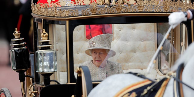 Britain's Queen Elizabeth rides in a carriage to attend the annual Trooping the Colour Ceremony in London, Saturday, June 8, 2019.