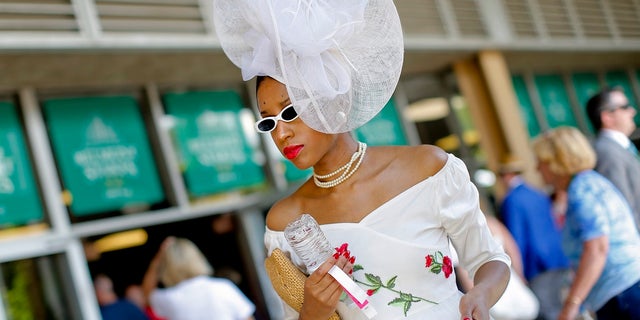 A spectator walks through the grandstand before the 151st running of the Belmont Stakes horse race, Saturday, June 8, 2019, in Elmont, N.Y. (AP Photo/Eduardo Munoz Alvarez)