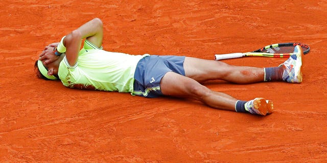 Spain's Rafael Nadal celebrates his record 12th French Open tennis tournament title after winning his men's final match against Austria's Dominic Thiem in four sets at the Roland Garros stadium in Paris on Sunday.