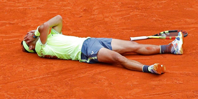 Spain's Rafael Nadal celebrates his record 12th French Open tennis tournament title after winning his men's final match against Austria's Dominic Thiem in four sets at the Roland Garros stadium in Paris on Sunday.