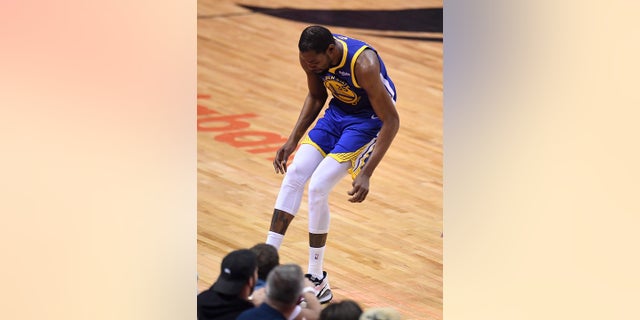 Golden State Warriors forward Kevin Durant (35) hobbles after injuring his right leg during first-half basketball action in Game 5 of the NBA Finals against the Toronto Raptors in Toronto, Monday, June 10, 2019. (Frank Gunn/The Canadian Press via AP)