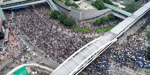 In this image made from aerial video, protesters gather in the streets outside the Legislative Council in Hong Kong, Wednesday, June 12, 2019. 