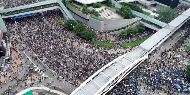 In this image made from aerial video, protesters gather in the streets outside the Legislative Council in Hong Kong, Wednesday, June 12, 2019. 