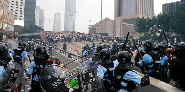 Riot police gather face off with demonstrators near the Legislative Council in Hong Kong, Wednesday, June 12, 2019.