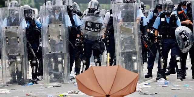Police in riot gear block a street near the Legislative Council in Hong Kong, Wednesday.