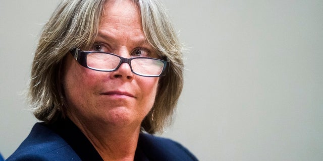In a Monday, Aug. 6, 2018, photo, Dr. Eden Wells listens to closing arguments from Special Prosecutor Todd Flood during the preliminary examination of Wells at Genesee County District Court in Flint, Mich. (Jake May/The Flint Journal via AP, File)