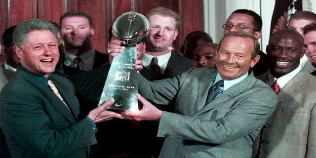 In this June 16, 1998, file photo, then President Clinton, left, and Denver Broncos owner Pat Bowlen hold the Vince Lombardi Trophy during a ceremony at the White House where the president honored the Super Bowl XXXII champions.