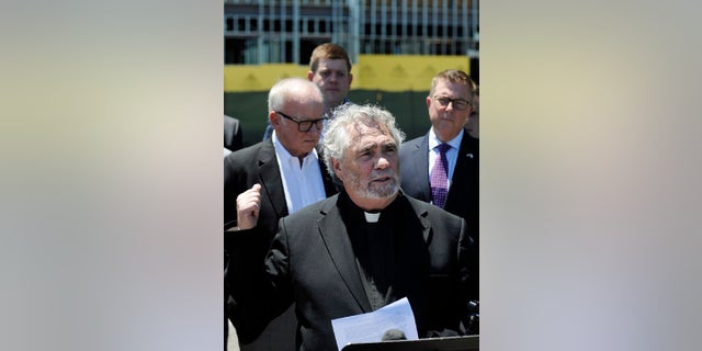 Anti-abortion activist Rev. Terry Gensemer gestures toward a new clinic being constructed by Planned Parenthood in Birmingham, Ala., on Thursday, June 13, 2019. The organization is working on the project despite a new state law that virtually bans abortion in Alabama. (AP Photo/Jay Reeves)