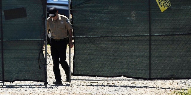 A security guard closes a gate at the construction site of a new clinic that is being built by Planned Parenthood in Birmingham, Ala., on Thursday, June 13, 2019. The organization is working on the project despite a new state law that virtually bans abortion in Alabama. (AP Photo/Jay Reeves)