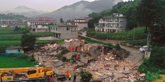 Rescue workers search for trapped people at a collapsed building after an earthquake in Shuanghe Town in Changning County of Yibin City, southwest China's Sichuan Province on Tuesday.