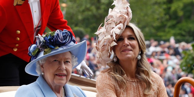 Queen Elizabeth II and Netherlands' Queen Maxima arrive on the day one of the annual Royal Ascot horse race meeting in Ascot, England. (AP Photo/Alastair Grant)