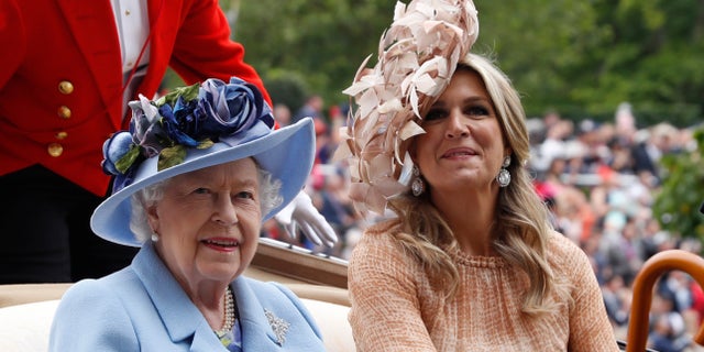 Queen Elizabeth II and Netherlands' Queen Maxima arrive on the day one of the annual Royal Ascot horse race meeting in Ascot, England. (AP Photo/Alastair Grant)