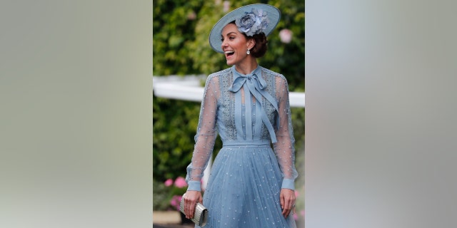Britain's Kate, Duchess of Cambridge, smiles upon her arrival on the day one of the annual Royal Ascot horse race meeting in Ascot, England, Tuesday, June 18, 2019. (AP Photo/Alastair Grant)