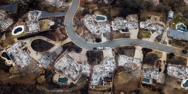 This Dec. 3, 2018, file photo, shows homes leveled by the Camp Fire line Valley Ridge Drive in Paradise, Calif. (AP Photo/Noah Berger, File)