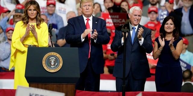 First Lady Melania Trump, President Donald Trump, Vice President Mike Pence, and Karen Pence greet supporters at a rally in Orlando, Florida, on Tuesday, June 18, 2019, officially announcing bids for re-election in 2020. Masu (AP Photo / John Raoux)