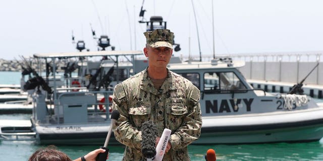 Cmdr. Sean Kido of the U.S. Navy's 5th Fleet talks to journalists at a 5th Fleet Base near Fujairah, United Arab Emirates, Wednesday, June 19, 2019. Cmdr. Kido said Wednesday that damage done last week to the Kokaku Courageous was "not consistent with an external flying object hitting the ship."