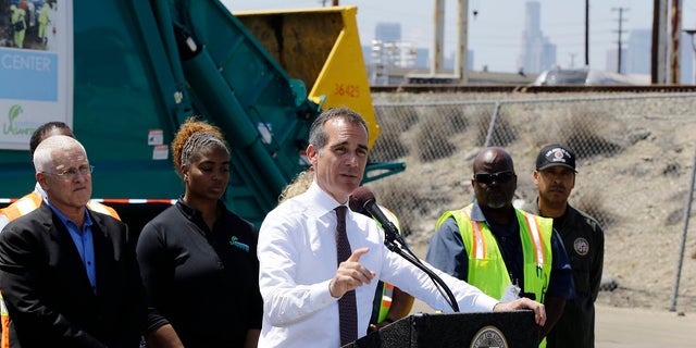 Los Angeles Mayor Eric Garcetti on the podium, surrounded by city sanitation workers, talks about the homelessness problem in the city at a press conference in Los Angeles on June 19 2019. Councilor Mike Bonin, on the far left, is the city councilor. (AP Photo / Damian Dovarganes)