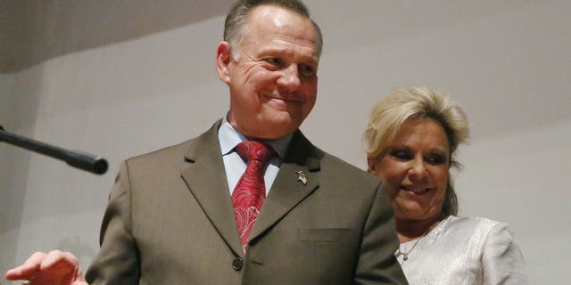 Then-candidate Roy Moore walks off the stage with wife Kayla Moore after an election-night watch party at the RSA activity center, in Montgomery, Ala., on Dec. 12, 2017. (AP Photo/Brynn Anderson, File)