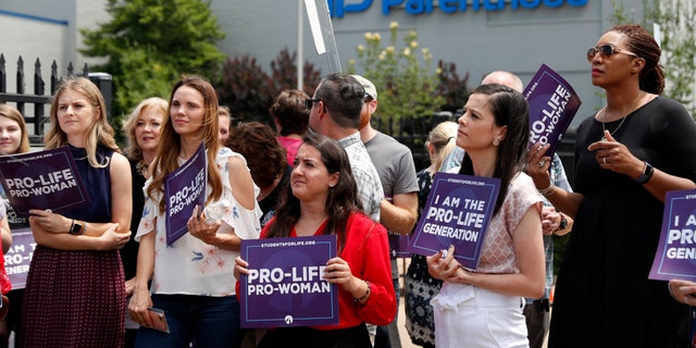 FILE - In this June 4, 2019, file photo, anti-abortion advocates gather outside the Planned Parenthood clinic in St. Louis. (AP Photo/Jeff Roberson, File)