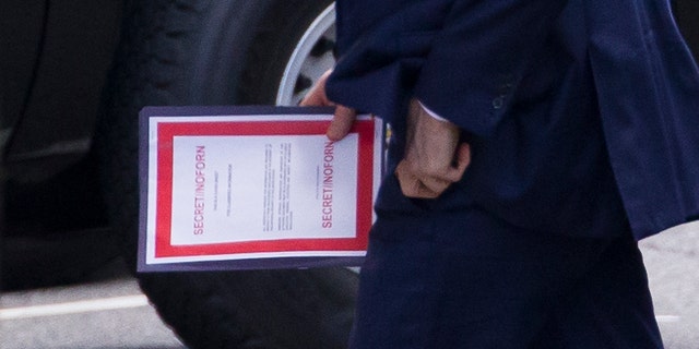 Outgoing Acting Defense Secretary Patrick Shanahan carrying a document labeled secret as he arrived for a meeting with President Trump about Iran at the White House on Thursday.