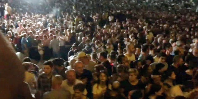 In this image from video, thousands of protesters gather outside the Parliament in Tbilisi on Thursday. (AP Photo)